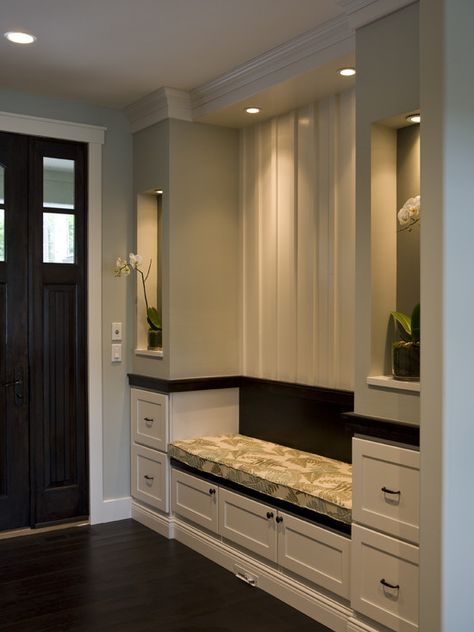 A kitchen with marble counter tops and stainless steel appliances on the wall, along with hanging lights hanging from the ceiling over the ceiling in front of a wooden counter top of a kitchen counter top space next to